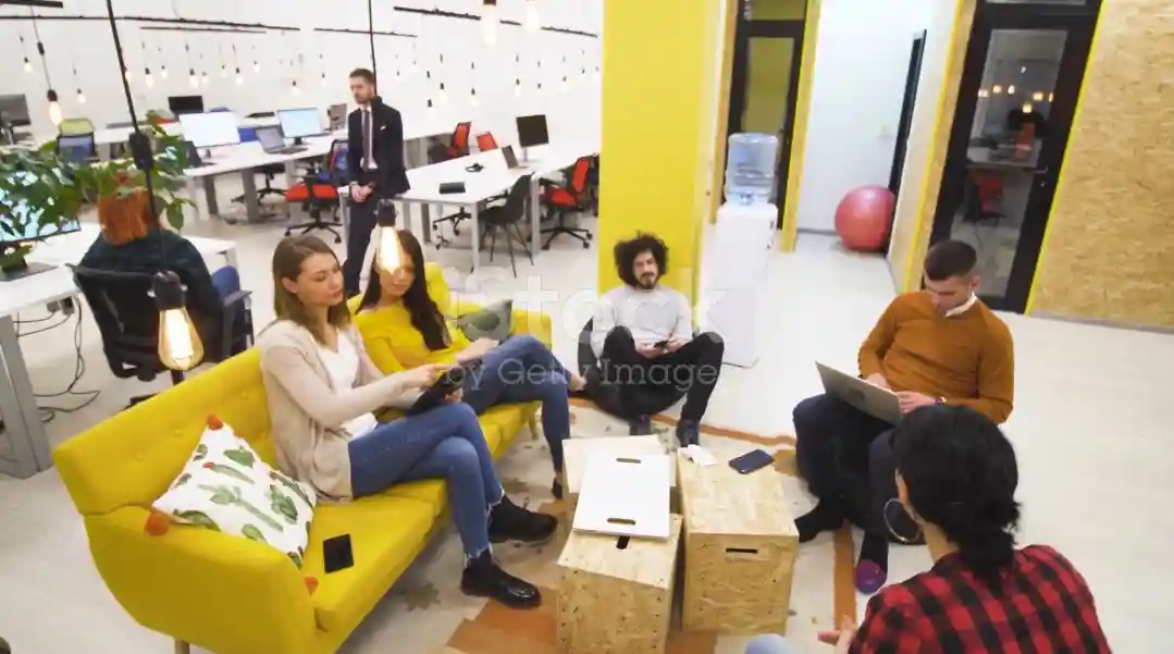 Image of employees smiling and collaborating in a positive work environment at American Big Socks Company.